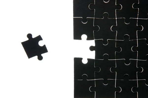 Assembled puzzle without one piece lying near him — Stock Photo, Image