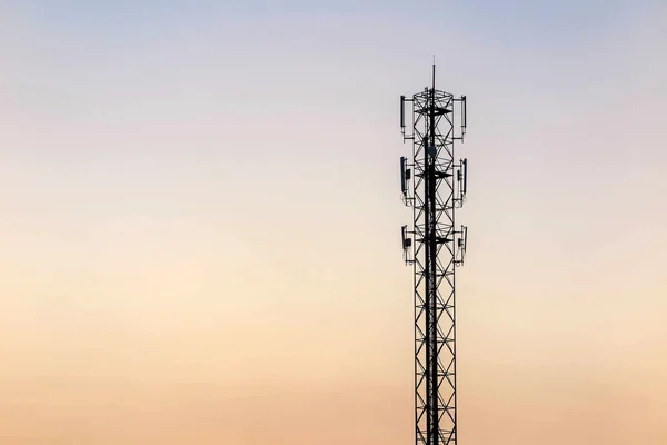 Telecommunication cellular tower on twilight background