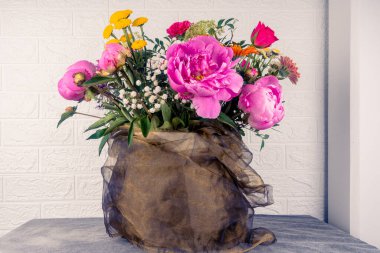 Büyük ve güzel bir buket, şakayıklı, beyaz arka planda güller. Tebrikler konsepti..