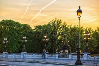 lone passerby on Alexander III bridge at dawn