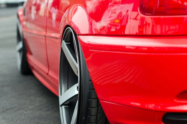 The rear part of modern stylish red car with wheel — Stock Photo, Image