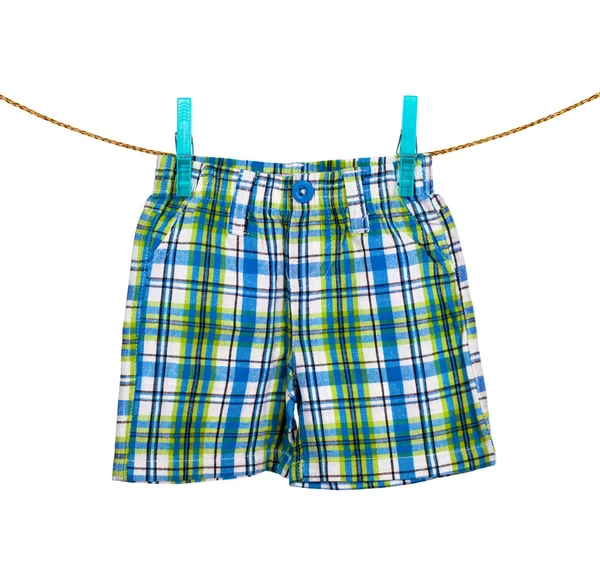 Shorts hanging on the clothesline on white background — Stock Photo, Image