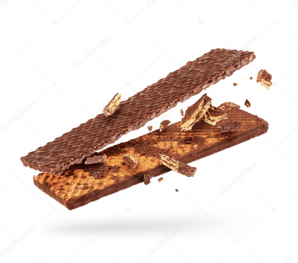 Chocolate waffle is breaking into two halves in the air on a white background