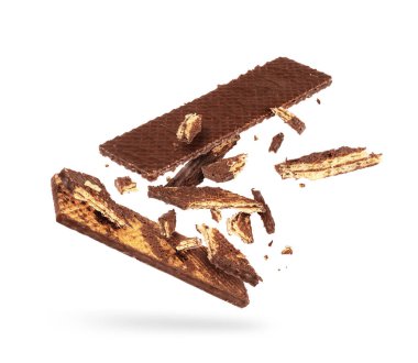 Çikolatalı waffle beyaz arka planda havada birçok parçaya ayrılıyor.