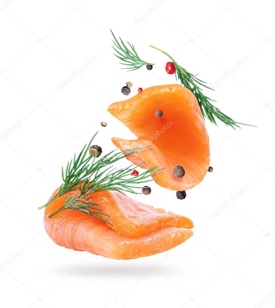 Two slices of fresh red fish with flavored spices close-up, isolated on a white background