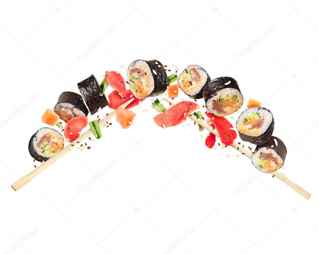 Fresh maki sushi rolls with ginger frozen in the air on white background