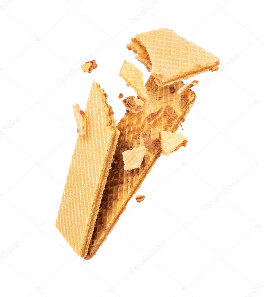 Crispy waffle is breaking into pieces in the air, isolated on a white background