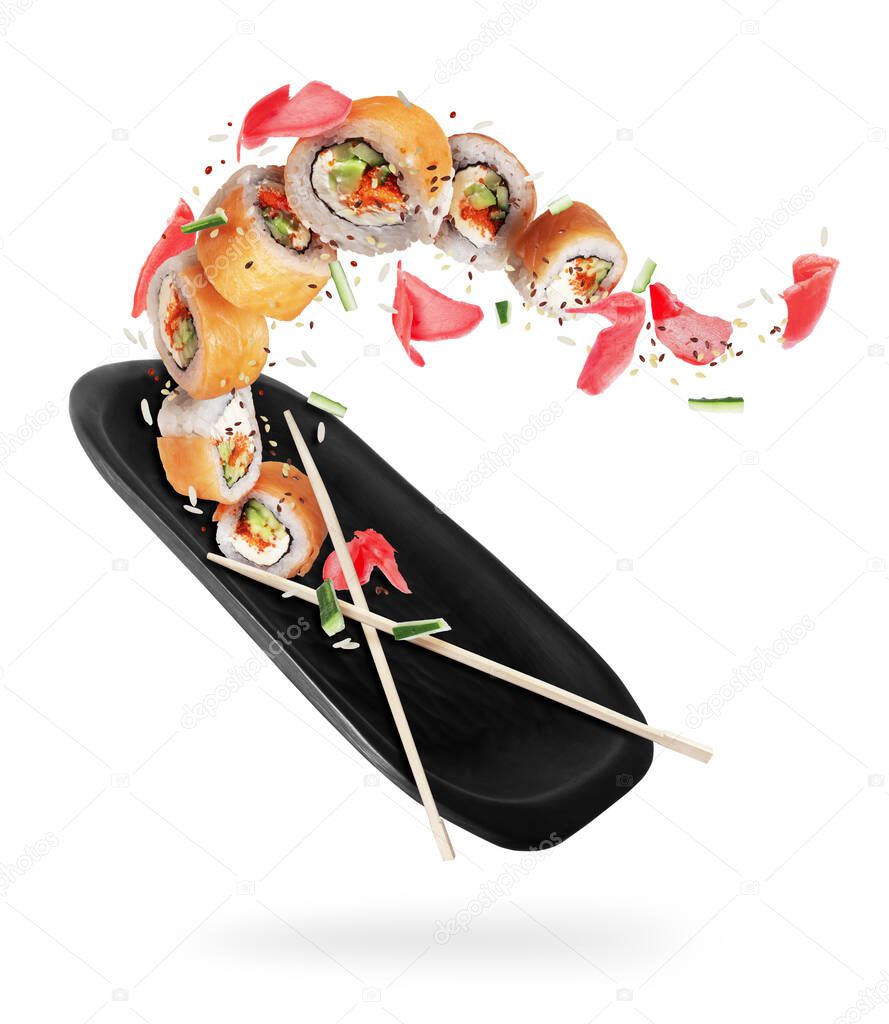 Fresh sushi rolls with clay plate in the air on a white background 