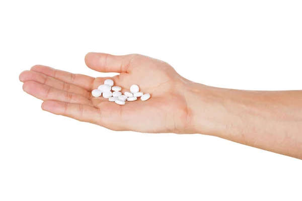 Hand holding pills isolated on white background — Stock Photo, Image