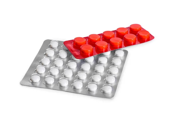 Két fólia csomag tabletták elszigetelt fehér background — Stock Fotó