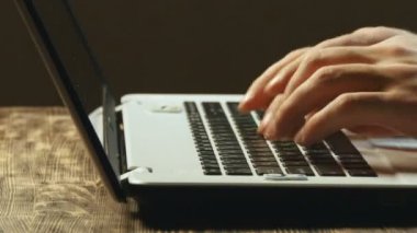 Eller dizüstü bilgisayarda klavyede yazıyor.