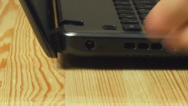Visão de close-up da carga da bateria do laptop da inserção do homem — Vídeo de Stock