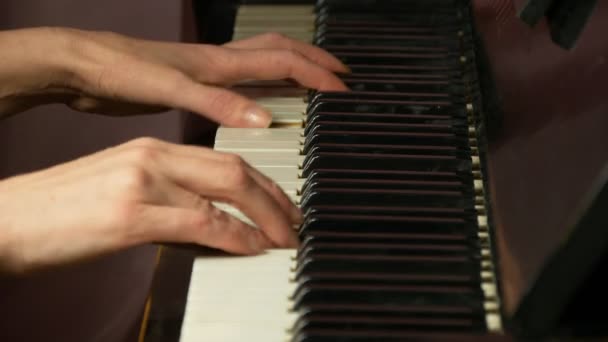 Two female hands playing a gentle piece of classical music on a beautiful grand piano. Woman playing the piano, close-up. — Stock Video