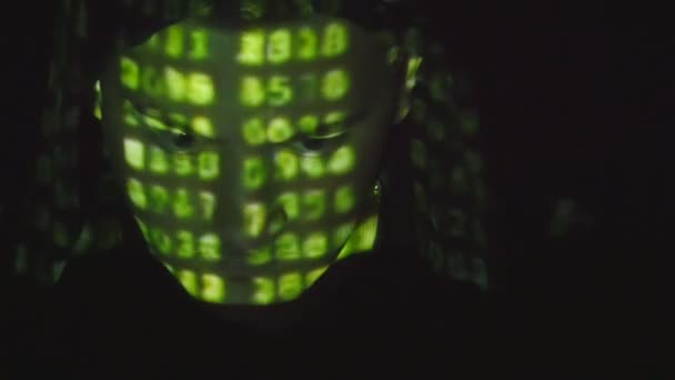 Source code projected over an angry hostile mans face, black background. — Stock Video