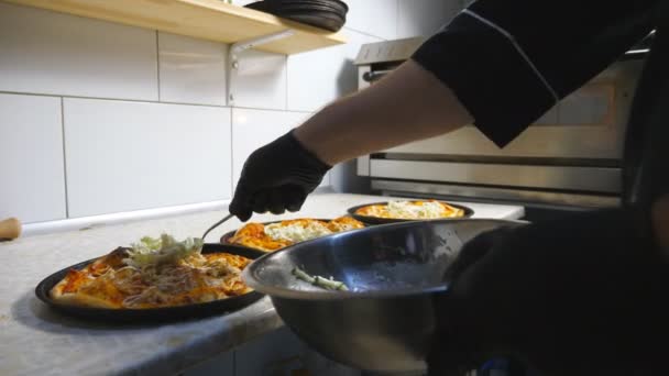 Male hand of cook in glove putting a cabbage mixed in mayonnaise on pita bread using a spoon at kitchen. Chef preparing to serve dish at restaurant. Concept of cooking food. Slow motion — Stock Video