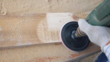 Close up of woodworking tool in hand of professional worker. Unrecognizable carpenter working in his workshop. Artisan processing workpiece for some wooden product. Top view Dolly shot