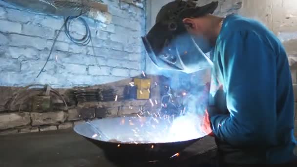 Man welding parts of the metal detail together at industrial manufacture. Worker in protective mask welding metal construction at metalworking production. Welder doing joint between two steel details — Stock Video