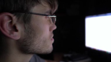 Focused male trader analyzing cryptocurrency market trends on computer screen, showcasing intense concentration and engagement in digital trading environment, capturing the essence of modern finance.
