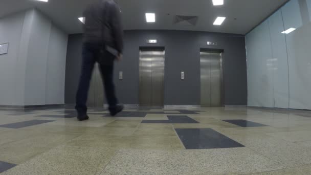 Young man wait for an elevator, when it arrives. Wide view, recorded from low viewpoint — Stock Footage Young man wait for an elevator, when it arrives. Wide view, recorded from low viewpoint Stock Footage