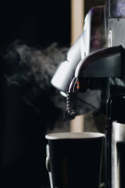Preparing a cup of espresso coffee using a coffee machine.