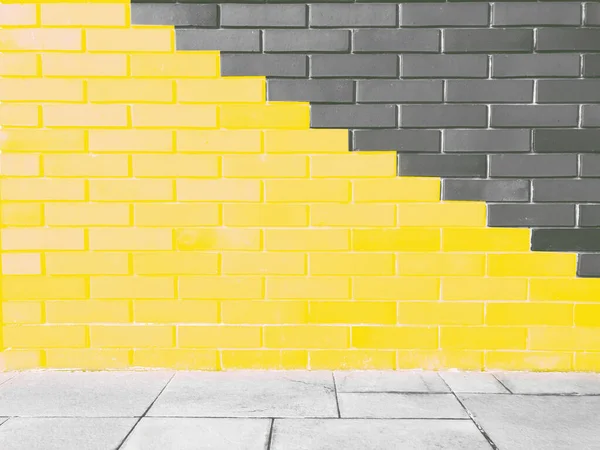 Abstracto brillante iluminando colores amarillos y grises de ladrillo de pared como fondo. — Foto de Stock