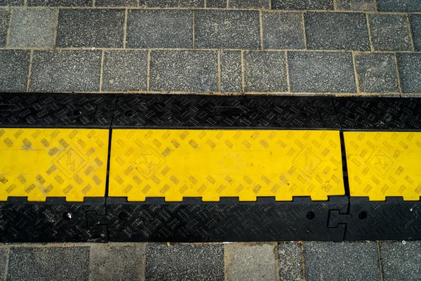 Rubber speed bump on road — Stock Photo, Image