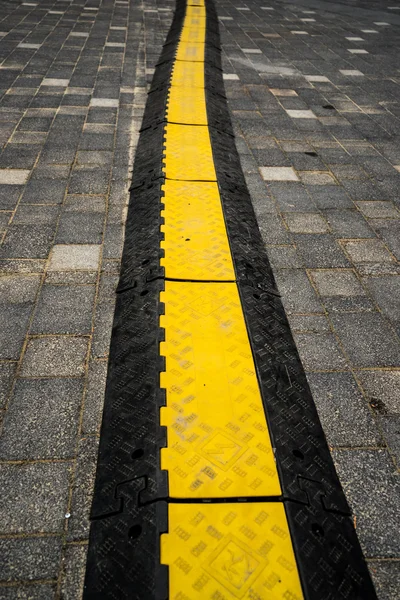 Rubber speed bump on a road — Stock Photo, Image