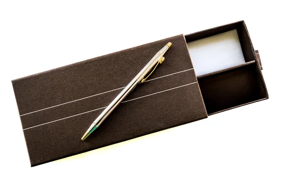 A pen on a gift box isolated on white — Stock Photo, Image