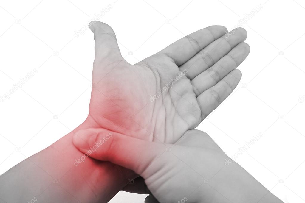 Pain in a wrist. holding hand to spot of wrist pain.