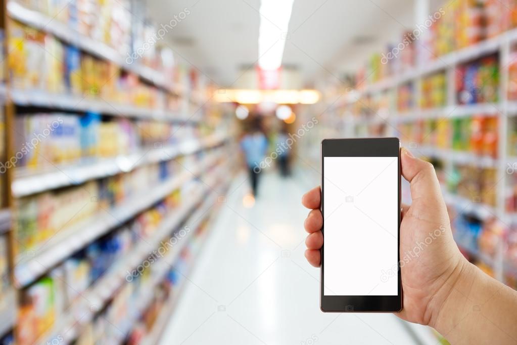 hand holding mobile phone on Supermarket blur background, business concept