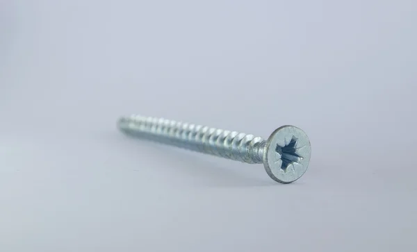 Metal screw on a white background — Stock Photo, Image