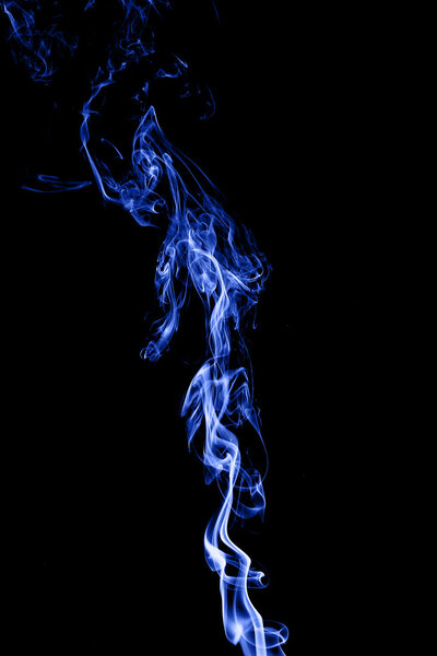 Color smoke on black background from the incense sticks