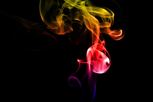 Abstract colorful smoke on black background from the incense sticks