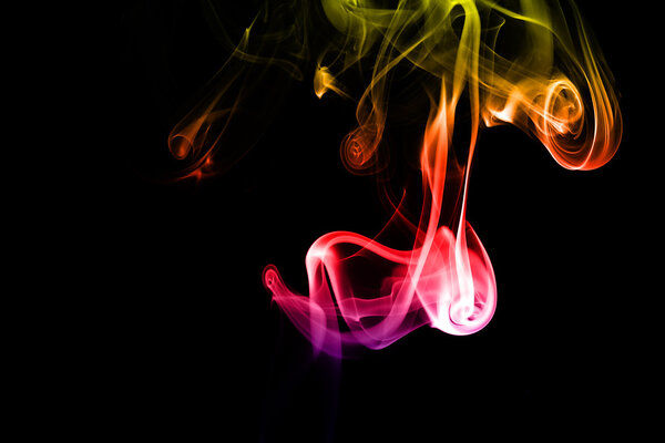 Abstract colorful smoke on black background from the incense sticks