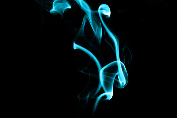 Abstract cyan smoke on black background from the incense sticks