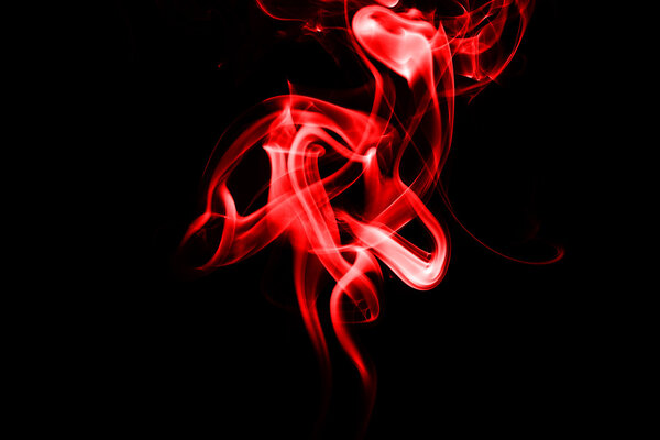 Abstract red smoke on black background from the incense sticks