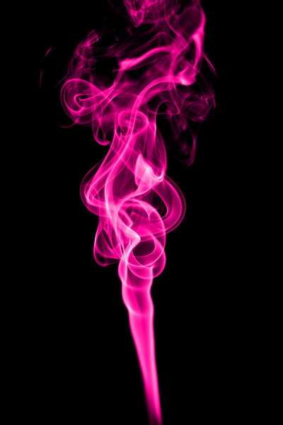 Abstract pink smoke on black background from the incense sticks