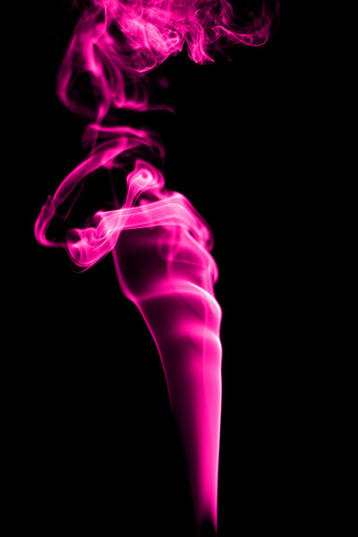 Abstract pink smoke on black background from the incense sticks