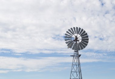 Old west style farm windmill with spinning blades clipart