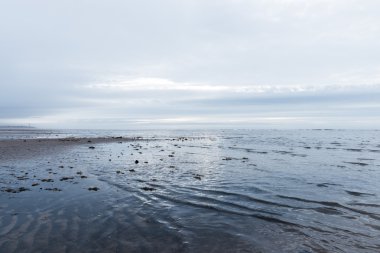 kasvetli bir bulutlu gün bir plaj akan rahatlatıcı ve yumuşak yatıştırıcı dalgalar