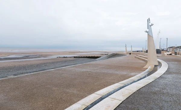 Cleveleys, England, 01/17/2016, Icy cold promenade leading down to a beach on a gloomy winters day