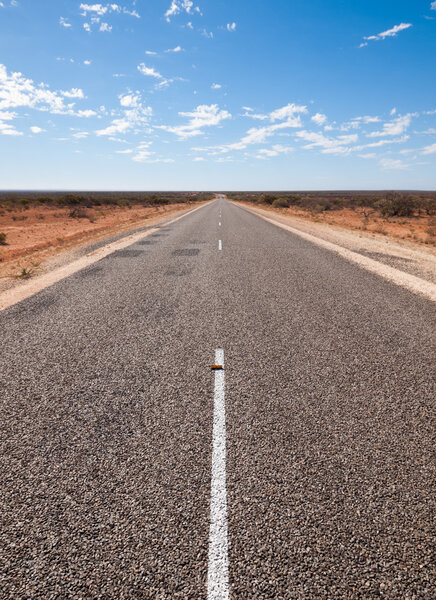 Australia, Outback, 09/10/2015, Long outback australian road with a beautiful blue sky disappearing into the horizon