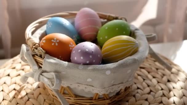 Happy Easter. Close up of painted eggs in a basket rotating in circle. POV. — Stock Video