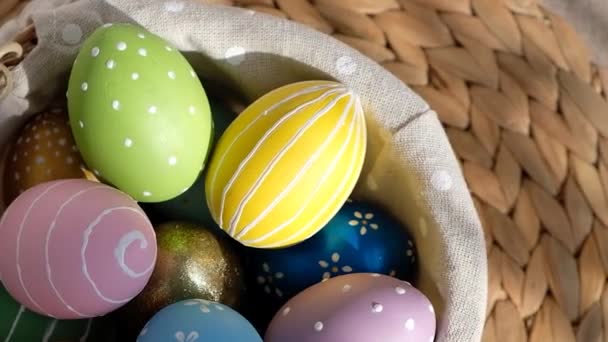 Happy Easter. Close up of painted eggs in a basket rotating in circle. POV. — Stock Video