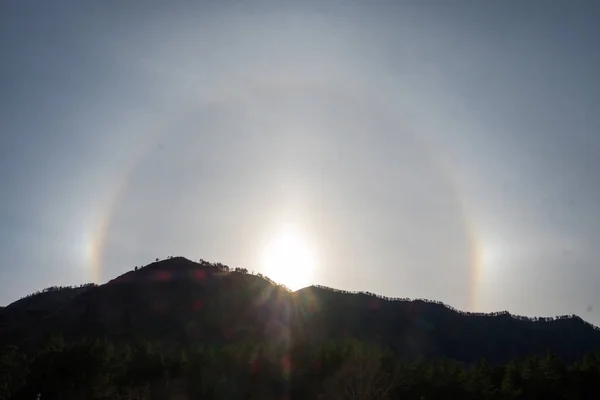 Beautiful Natural phenomenon Sun halo with cloud in the sky in the mountains.