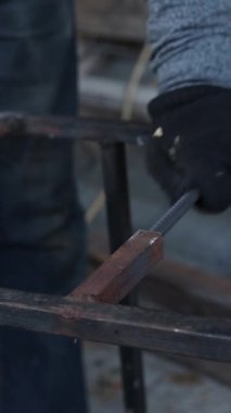 Güvenlik kurallarını ihlal eden bir üçkağıtçıyla çalışmak. Öğütücüyle takviye kesiyorum, yakın plan. İnşaat ya da onarım işi. Bir adam metal bir diskle öğütücüyle çalışırsa kıvılcımlar uçuşur.