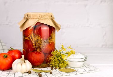 Ahşap masada kavanozda ev yapımı lezzetli domates turşusu. Geleneksel sonbahar yiyecek deposu. Ev yapımı sebze turşusu. Yakın plan. Boşluğu kopyala.