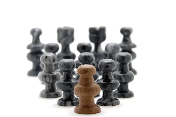 Chess pieces, white pawn leading black pieces — Stock Photo, Image