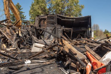 House in ruins from a fire, demolished, on a blue, cloudless sky 