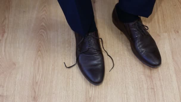 Man tying patent leather shoes formal and festive dressing. — Stock Video